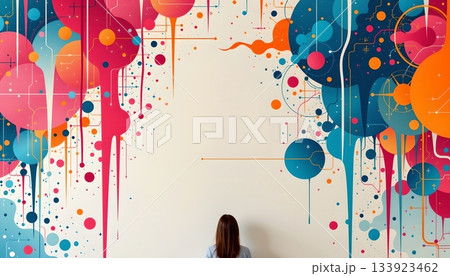 A person standing in front of a colorful abstract painting featuring a pattern of circles, lines, and splatters 133923462
