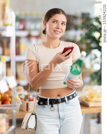 Young woman scanning qr code of soda 133924228