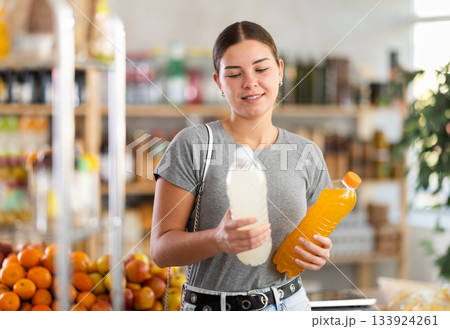 Young woman choosing soda in grocery store Young woman choosing soda in grocery store 133924261