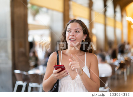 Young woman with phone walking around Barcelona Young woman with phone walking around Barcelona 133924352