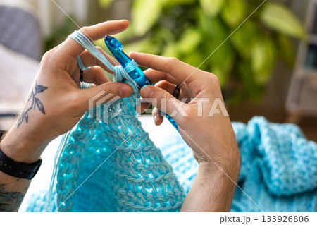 Man hands crochets handmade crocheting supplies assorted wool yarn hook knitting top view closeup 133926806