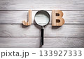 Magnifying Glass Searching for Job Concept on Wooden Surface with Wooden Letters J and B 133927333