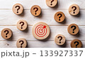 Wooden Target Icon Surrounded by Question Marks on White Rustic Wooden Background Business Concept 133927337