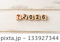 Red Question Mark Icon with Wooden Blocks Spelling 2026 Representing Uncertainty or Planning the Future 133927344
