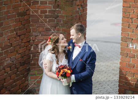 Smiling Bride and Groom Facing Each Other Outdoors 133929214