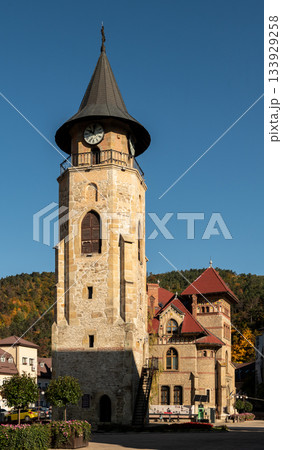 Medieval stone clock tower stands tall under clear Piatra Neamt sky 133929258