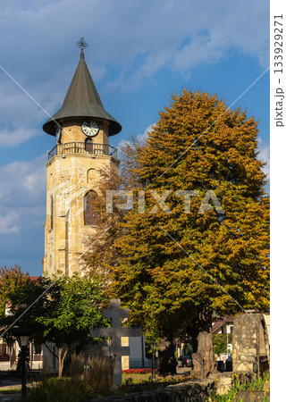 Medieval clock tower framed by autumn trees Piatra Neamt Romania Medieval clock tower framed by autumn trees Piatra Neamt Romania 133929271