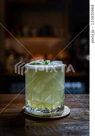 Basil cocktail on wooden bar 133930968