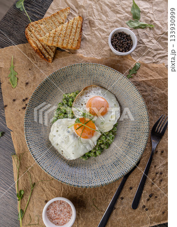 Fried eggs with green peas Fried eggs with green peas 133930999