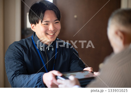 宅食弁当を渡す配達員 133931025