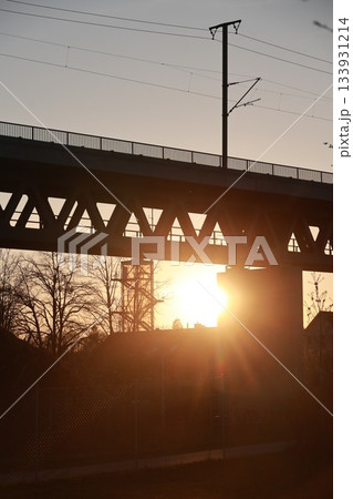 A bridge with a sun shining through it 133931214