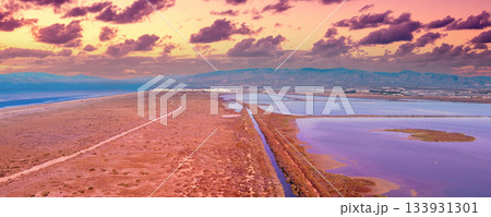 Salty lake in Cabo de Gata Reserve at sunset. Las Salinas de Cabo de Gata. Aerial view. Almeria, Spain. Horizontal banner 133931301