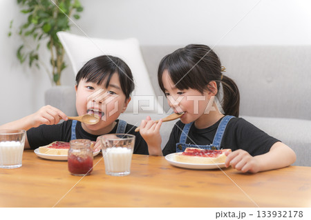 食パンにジャムをのせて食べる子どもたちの家庭的な朝の時間の写真素材 [133932178] - PIXTA