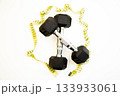 Dumbbells positioned on a clean white surface, surrounded by a measuring tape, representing fitness goals, health awareness, and the importance of physical activity for well-being 133933061