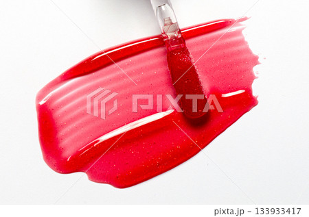 A sample of lip moisturizer on a white background. Oil or lip balm. A sample of lip moisturizer on a white background. Oil or lip balm. 133933417