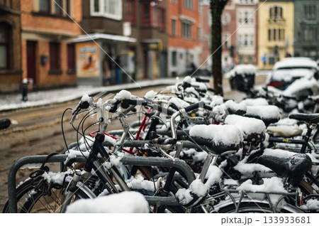 Black bicycle under the snow outside after a snowfall in town. 133933681