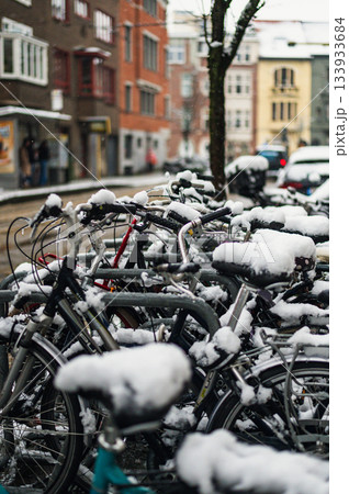 Black bicycle under the snow outside after a snowfall in town. Black bicycle under the snow outside after a snowfall in town. 133933684