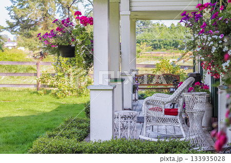 Summer terrace, table and chairs with flowers in a countryside. 133935028