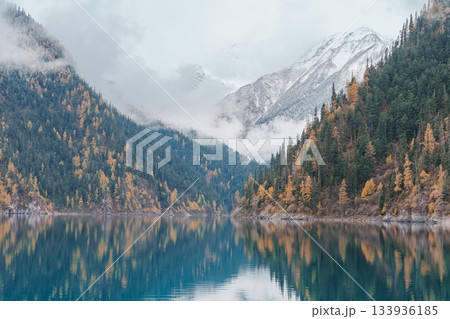 Scenery Jiuzhaigou national park in Sichuan, China. Beautiful Long lake and snow mountain in Autumn season. Famous Landmark and Vacation near Chengdu, China. Asia travel concept Scenery Jiuzhaigou national park in Sichuan, China. Beautiful Long lake and snow mountain in Autumn season. Famous Landmark and Vacation near Chengdu, China. Asia travel concept 133936185