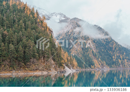 Scenery Jiuzhaigou national park in Sichuan, China. Beautiful Long lake and snow mountain in Autumn season. Famous Landmark and Vacation near Chengdu, China. Asia travel concept Scenery Jiuzhaigou national park in Sichuan, China. Beautiful Long lake and snow mountain in Autumn season. Famous Landmark and Vacation near Chengdu, China. Asia travel concept 133936186