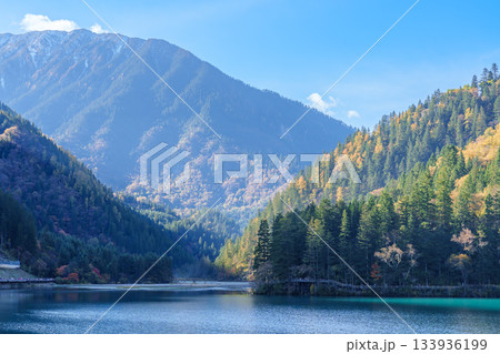 Scenery Jiuzhaigou national park in Sichuan, China. Beautiful of Arrow Bamboo Lake and snow mountain in Autumn season. Famous Landmark and Vacation near Chengdu, China. Asia travel concept Scenery Jiuzhaigou national park in Sichuan, China. Beautiful of Arrow Bamboo Lake and snow mountain in Autumn season. Famous Landmark and Vacation near Chengdu, China. Asia travel concept 133936199