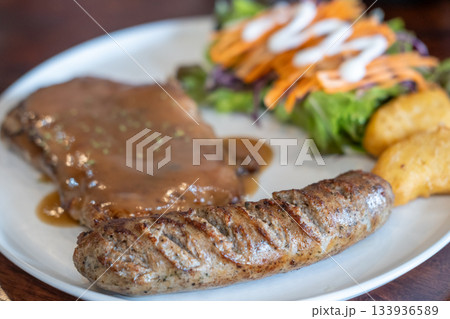 Set of grilled sausage with steak served on plate Set of grilled sausage with steak served on plate 133936589