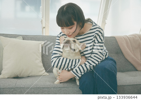 ソファでくつろぐ犬と女性 133936644