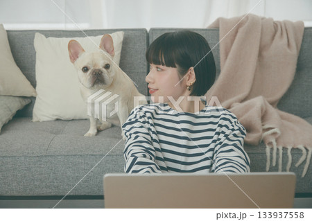 パソコン作業をする女性と見守る犬 133937558