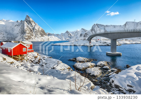 Winter view on Hamnoy village and bridge to Olenilsoya island. Winter view on Hamnoy village and bridge to Olenilsoya island. 133938230