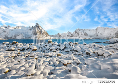 Shore of Reinefjorden on Toppoya island with Olstinden peak on background. Shore of Reinefjorden on Toppoya island with Olstinden peak on background. 133938239