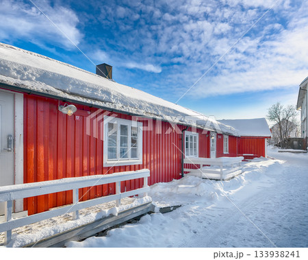 Traditional Norwegian red wooden houses on the shore of Reinefjorden in Hamnoy village . Traditional Norwegian red wooden houses on the shore of Reinefjorden in Hamnoy village . 133938241