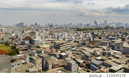 Aerial view of houses in the slums of Jakarta and the panorama of the city. Indonesia. 133939176