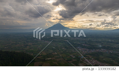 Farmland and active Sinabung volcano. Agricultural landscape in Sumatra. Berastagi, Indonesia. Farmland and active Sinabung volcano. Agricultural landscape in Sumatra. Berastagi, Indonesia. 133939182