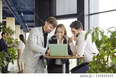 Smiling friendly helpful colleagues working young diverse businesspeople at desk brainstorm, discuss Smiling friendly helpful colleagues working young diverse businesspeople at desk brainstorm, discuss 133939344