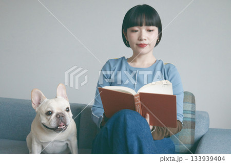 ソファで本を読む女性と犬 ソファで本を読む女性と犬 133939404