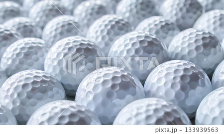 a pile of white golf balls, close-up, on a plain background 133939563