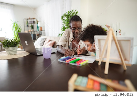Mother and child drawing together while working from home 133940812