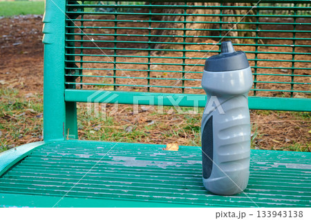 Outdoor. Thermos of coffee on a public bench 133943138