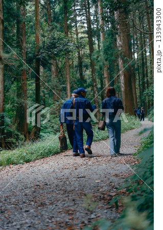 森林の参道を親子3人で歩くシーン 133943300