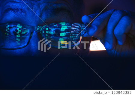 Analyzing stock market data on a screen at night 133943383