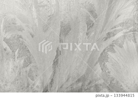 Abstract icy textures form a serene, frosted landscape in soft gray tones. Demonstration Color of the Year 2026. 133944815