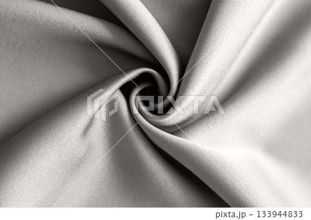 Soft gray fabric swirl with smooth folds and dramatic texture Demonstration Color of the Year 2026. 133944833
