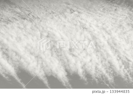 Soft gray clouds fill the sky in a calm, serene tapestry. Demonstration Color of the Year 2026. 133944835