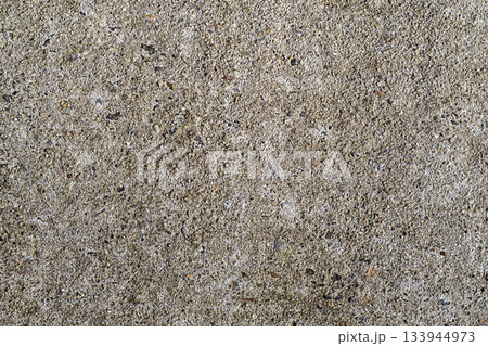 Concrete texture closeup with rough gray surface and embedded stones for background use in design Concrete texture closeup with rough gray surface and embedded stones for background use in design 133944973