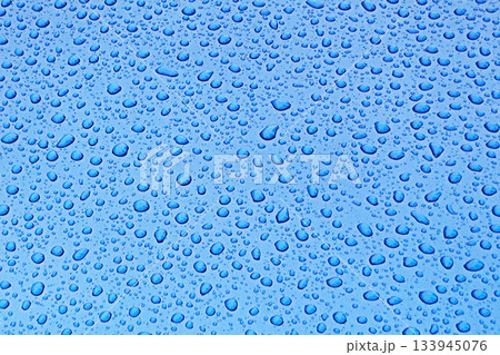Blue water droplet pattern on glass surface, refreshing background for design projects Blue water droplet pattern on glass surface, refreshing background for design projects 133945076
