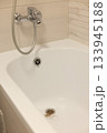 Water drain hole of a bathtub is clogged with long hair clump. 133945188