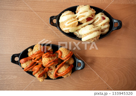 Savory bowls filled with delicious snacks drizzled with sauces for all appetites Savory bowls filled with delicious snacks drizzled with sauces for all appetites 133945320
