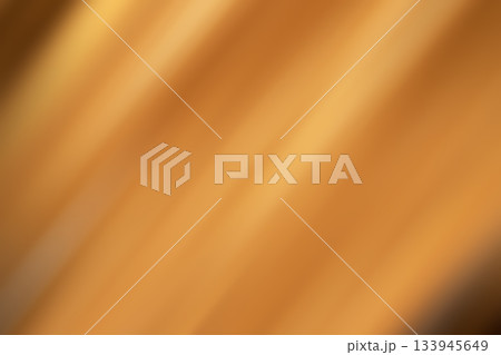 Bright orange abstract background with warm diagonal light streaks and soft gradient textures 133945649