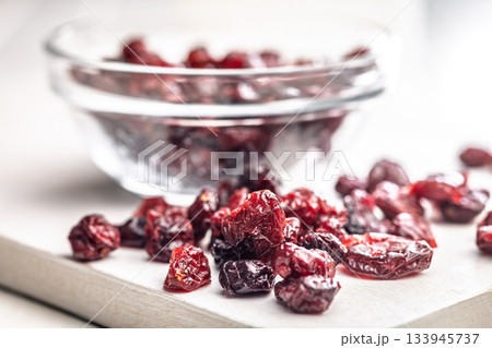 Tasty dried cranberries on white table. Tasty dried cranberries on white table. 133945737