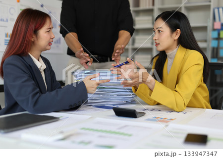 Female coworkers are arguing with each other and the manager is trying to stop them. Discussing about a huge pile of paperwork with their manager, workload and work stress in a corporate. Female coworkers are arguing with each other and the manager is trying to stop them. Discussing about a huge pile of paperwork with their manager, workload and work stress in a corporate. 133947347